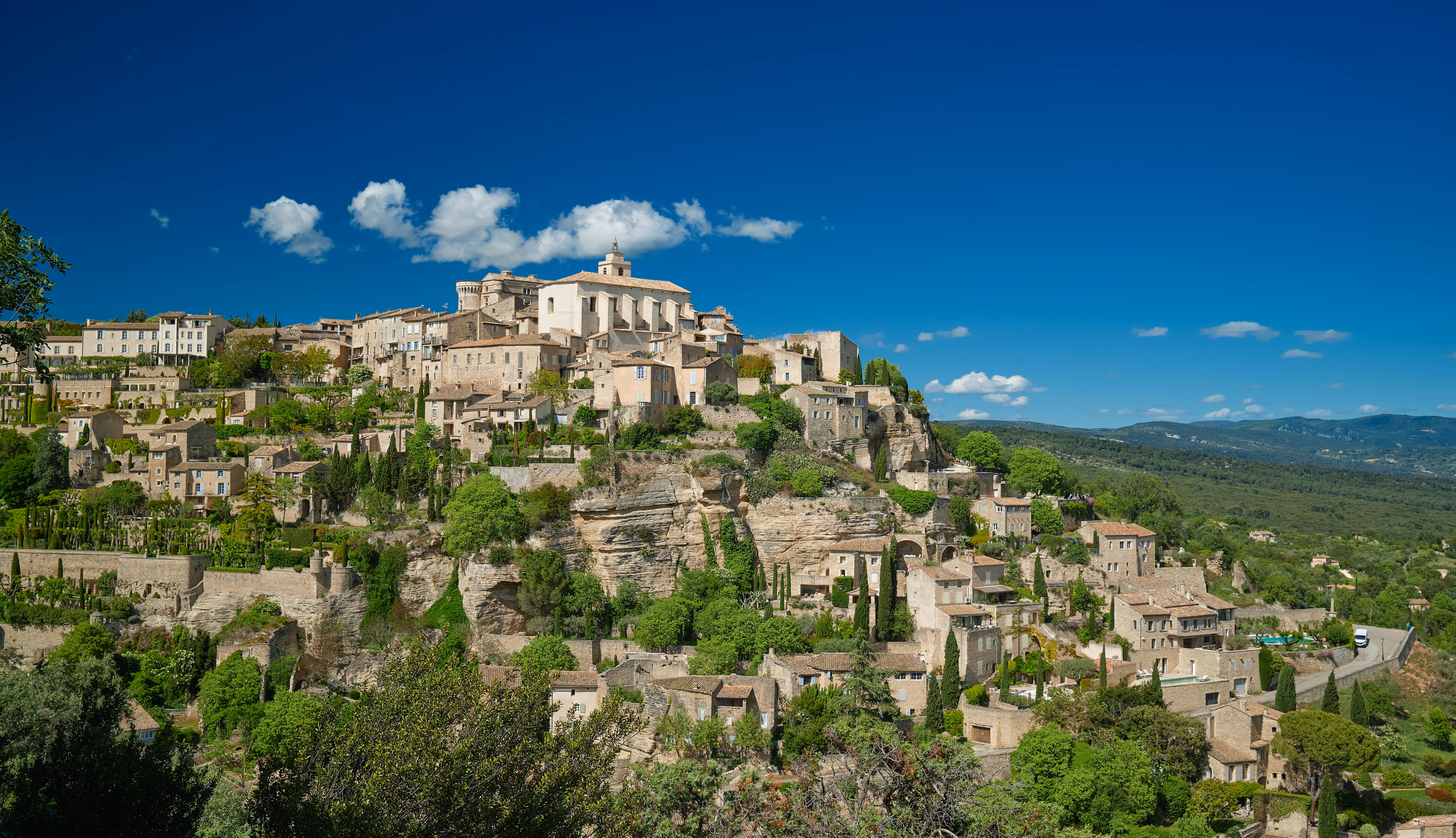 Gordes village perched on its hilltop, surrounded by lavender fields